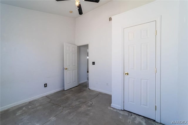 unfurnished bedroom with baseboards, a ceiling fan, and unfinished concrete floors