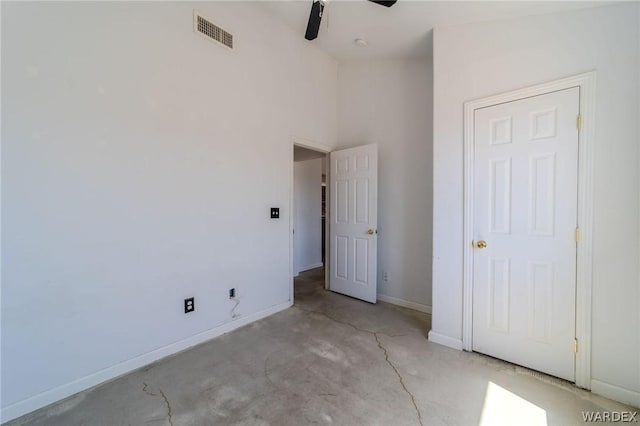 unfurnished bedroom featuring ceiling fan, concrete floors, visible vents, and baseboards