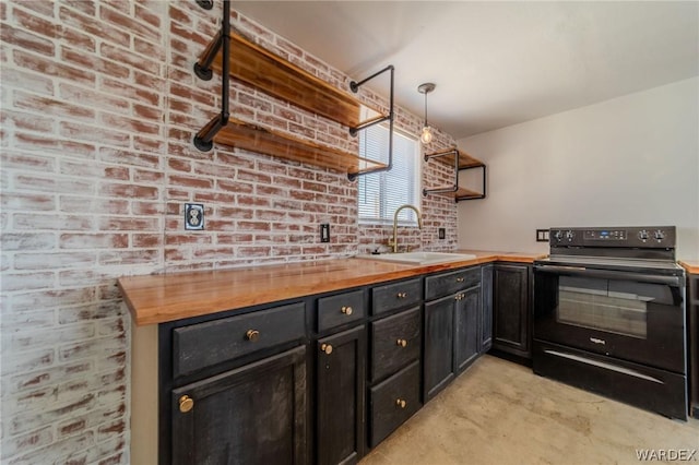 kitchen with pendant lighting, open shelves, black electric range oven, a sink, and wood counters