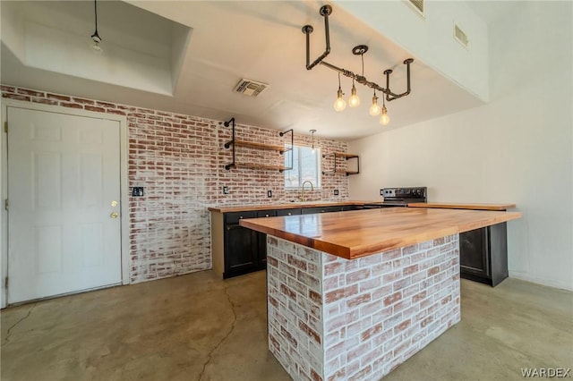 bar with brick wall, concrete floors, visible vents, and decorative light fixtures