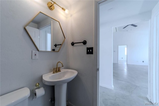 half bath with concrete flooring and toilet