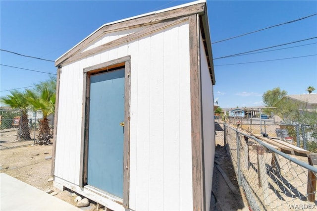 view of shed featuring fence