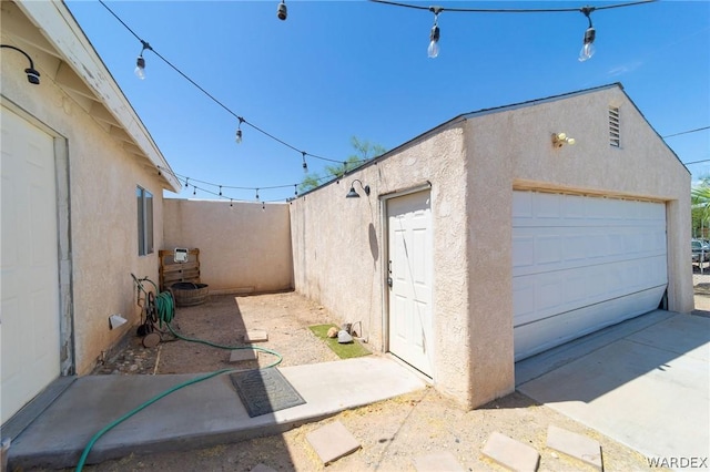 detached garage featuring fence