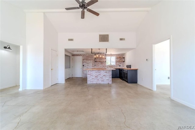 unfurnished living room featuring high vaulted ceiling and visible vents