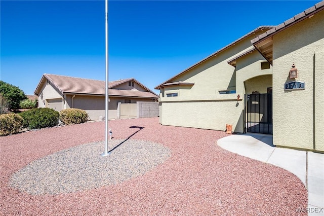view of yard featuring fence and a gate