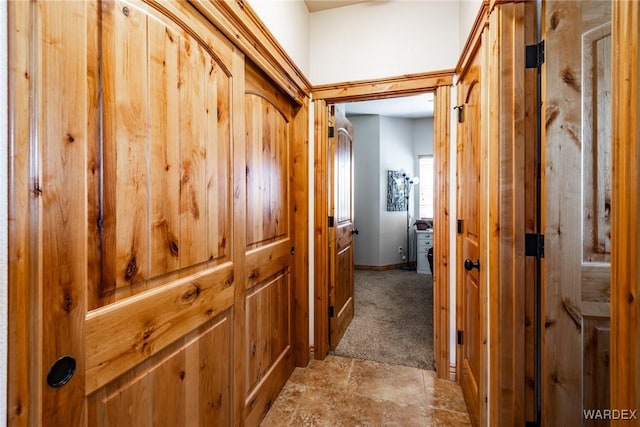 corridor with light carpet and baseboards