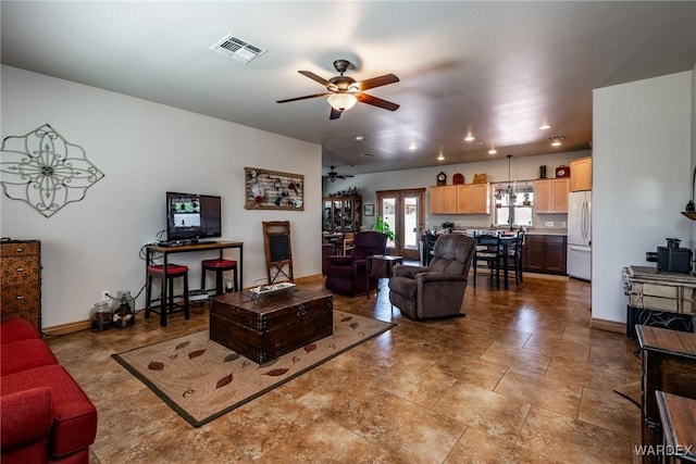 living area with baseboards, recessed lighting, and a ceiling fan