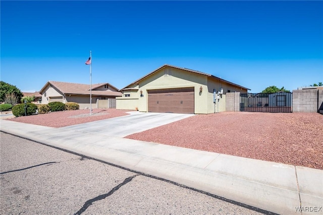 ranch-style house featuring stucco siding, a gate, fence, driveway, and an attached garage