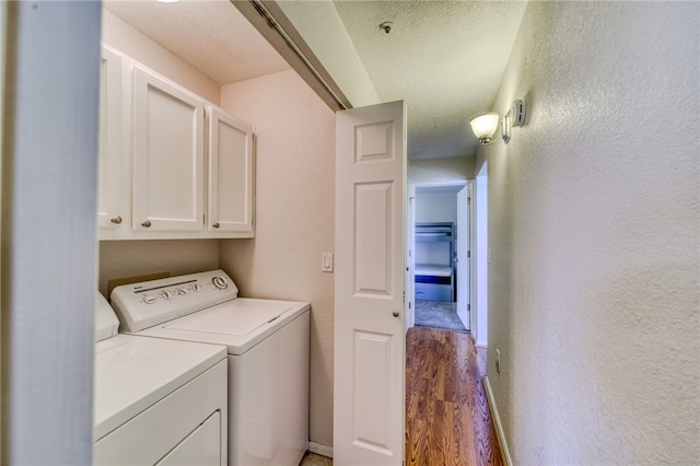 3408 Sunriver Rd Unit 207 B6, Bullhead City, AZ 86429 - laundry room featuring cabinet space, separate washer and dryer, wood finished floors, and baseboards
