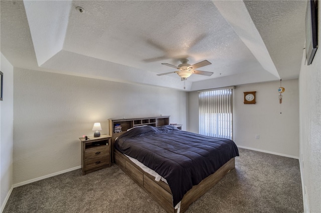 3408 Sunriver Rd Unit 207 B6, Bullhead City, AZ 86429 - bedroom with a tray ceiling, carpet flooring, a textured ceiling, baseboards, and a ceiling fan