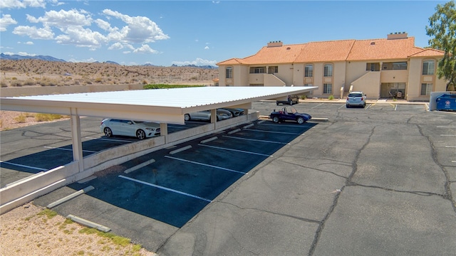 3408 Sunriver Rd Unit 207 B6, Bullhead City, AZ 86429 - uncovered parking lot featuring a mountain view
