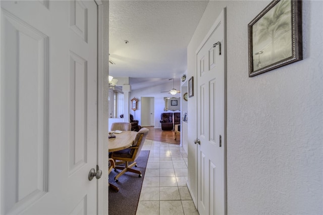 3408 Sunriver Rd Unit 207 B6, Bullhead City, AZ 86429 - corridor featuring a textured ceiling, light tile patterned floors, and a textured wall