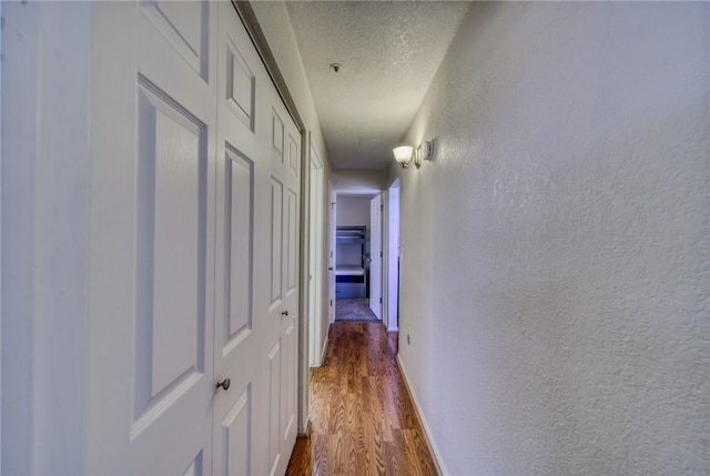 3408 Sunriver Rd Unit 207 B6, Bullhead City, AZ 86429 - hall with a textured ceiling, dark wood finished floors, a textured wall, and baseboards