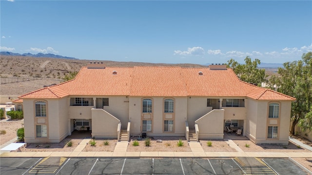 3408 Sunriver Rd Unit 207 B6, Bullhead City, AZ 86429 - view of building exterior with uncovered parking and a mountain view