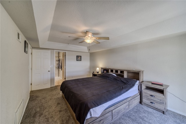 3408 Sunriver Rd Unit 207 B6, Bullhead City, AZ 86429 - bedroom featuring carpet floors, a raised ceiling, ceiling fan, baseboards, and a textured ceiling