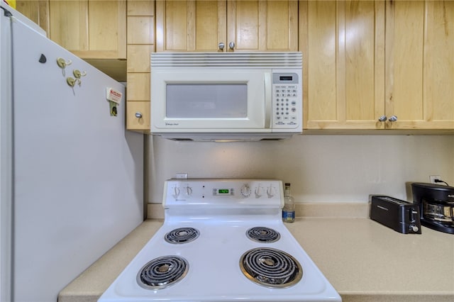 3408 Sunriver Rd Unit 207 B6, Bullhead City, AZ 86429 - kitchen featuring white appliances, light countertops, and light brown cabinetry
