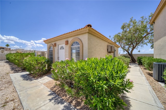 3408 Sunriver Rd Unit 207 B6, Bullhead City, AZ 86429 - view of property exterior with stucco siding, a tiled roof, and central air condition unit