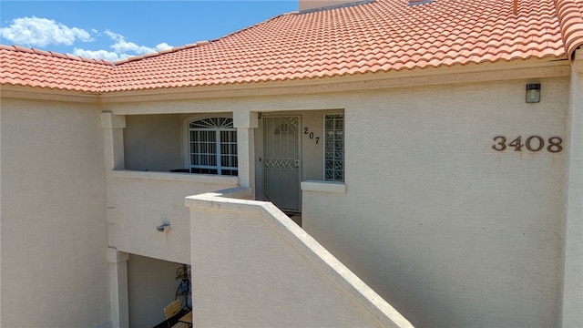 3408 Sunriver Rd Unit 207 B6, Bullhead City, AZ 86429 - property entrance with a tile roof and stucco siding