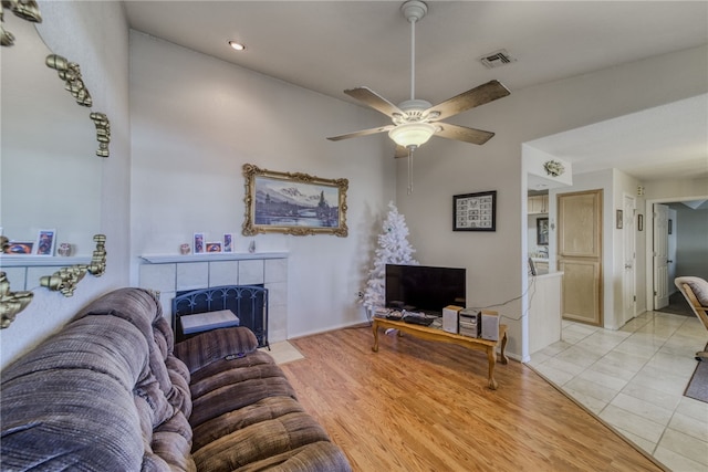 3408 Sunriver Rd Unit 207 B6, Bullhead City, AZ 86429 - living area featuring a ceiling fan, a tiled fireplace, light wood finished floors, and recessed lighting