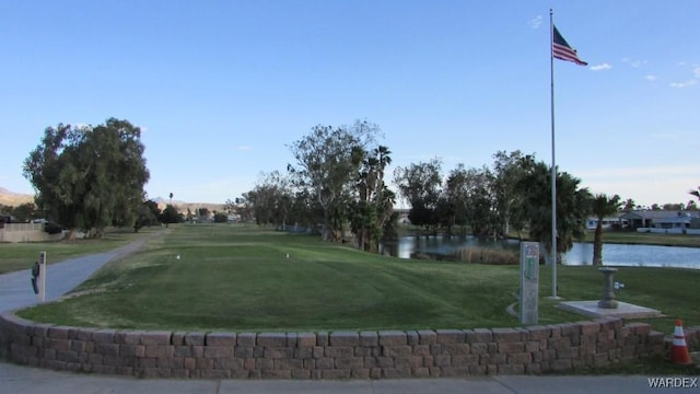 surrounding community with a yard and a water view