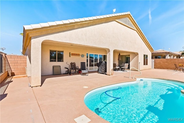 back of house with a patio area, fence, a fenced in pool, and stucco siding