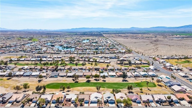 drone / aerial view featuring a residential view, a mountain view, and golf course view