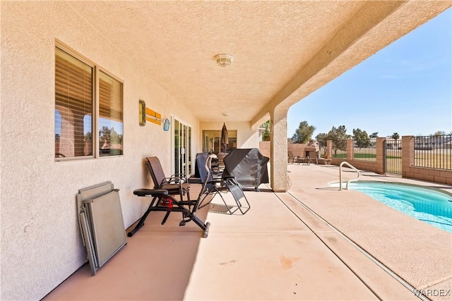 view of patio / terrace with a fenced in pool and fence