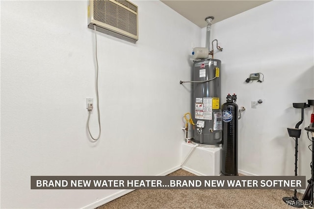 utility room with gas water heater and a wall mounted air conditioner