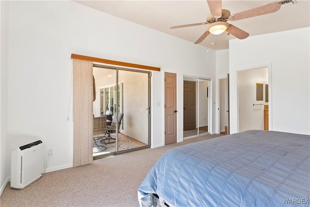 carpeted bedroom featuring ceiling fan, connected bathroom, visible vents, baseboards, and two closets