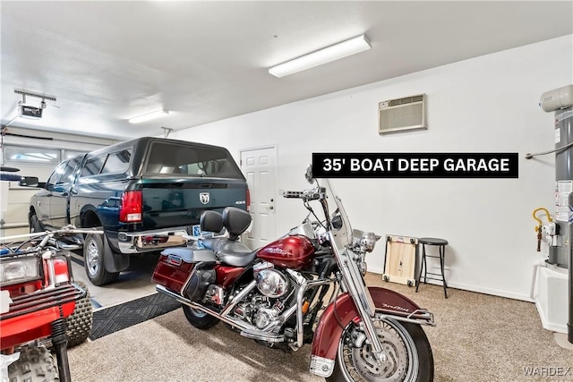 garage with a garage door opener, a wall unit AC, and baseboards