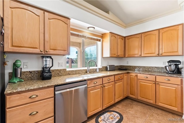 kitchen featuring light stone counters, light tile patterned flooring, vaulted ceiling, a sink, and dishwasher