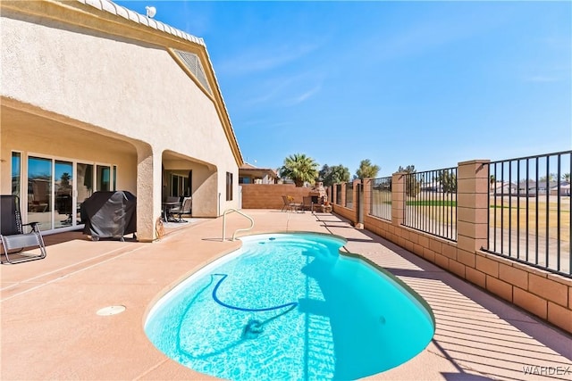 view of pool with fence, grilling area, a fenced in pool, and a patio