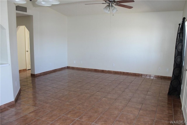 unfurnished room with visible vents, arched walkways, baseboards, ceiling fan, and tile patterned floors