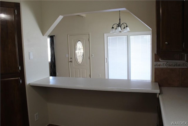 kitchen with a chandelier, pendant lighting, and light countertops