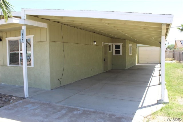 exterior space with an attached carport and stucco siding