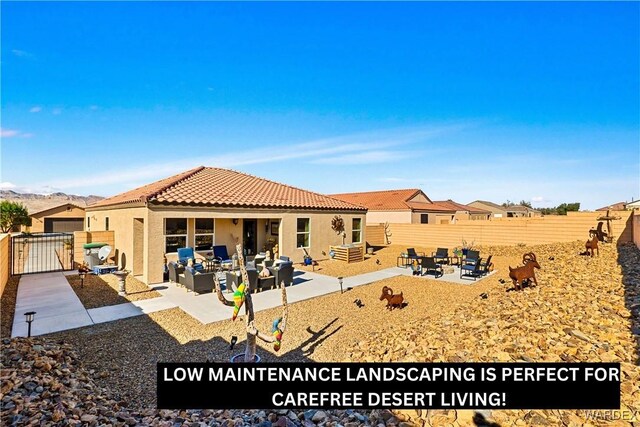 back of property with an outdoor living space with a fire pit, a patio, stucco siding, a fenced backyard, and a tiled roof