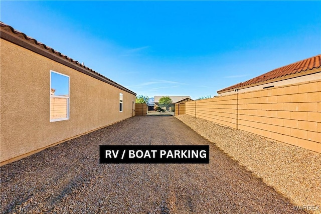 exterior space featuring a fenced backyard and stucco siding