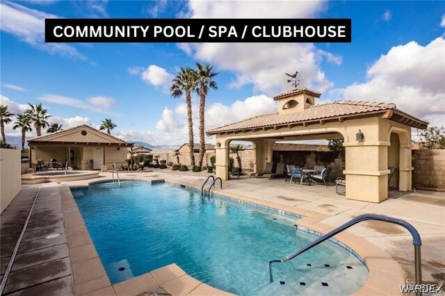 pool with a gazebo, a patio, and fence