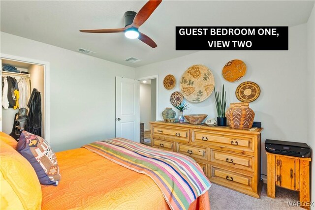 carpeted bedroom with a ceiling fan, a closet, and visible vents