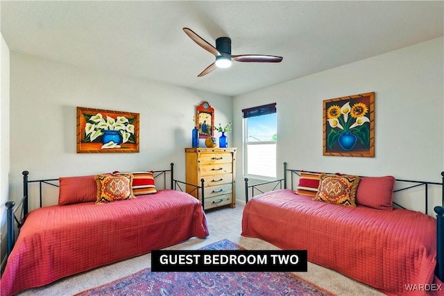 bedroom featuring a ceiling fan and light colored carpet