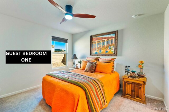 bedroom featuring baseboards, ceiling fan, and light colored carpet