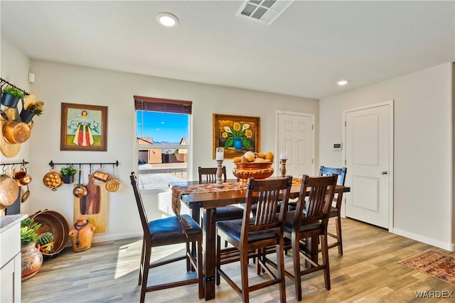 dining area with baseboards, light wood-type flooring, visible vents, and recessed lighting