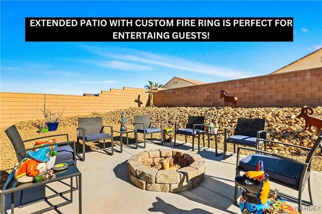 view of patio with a fenced backyard and a fire pit