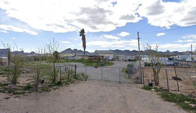 1097 S Dugas Rd, Golden Valley, AZ 86413 - view of dirt / gravel road with a gated entry, a residential view, and a gate