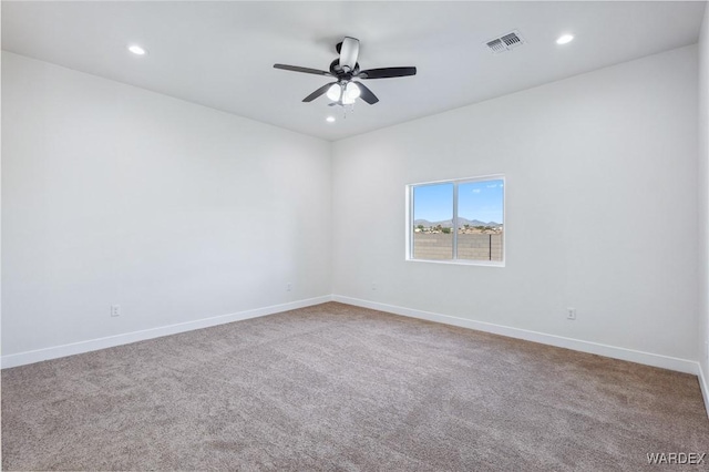 unfurnished room featuring recessed lighting, carpet flooring, visible vents, and baseboards