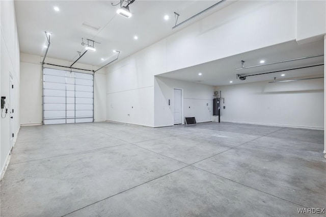 garage featuring water heater and a garage door opener