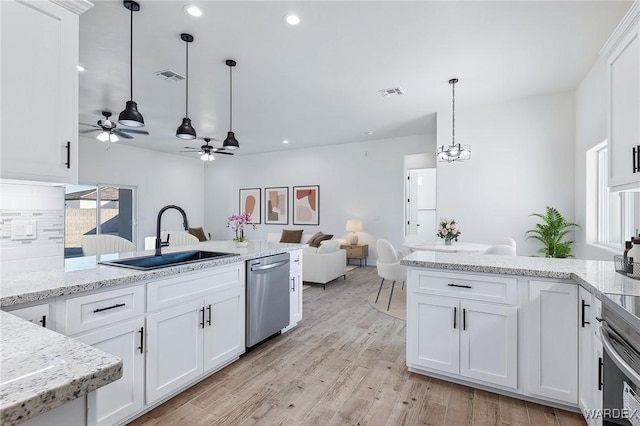 kitchen featuring appliances with stainless steel finishes, white cabinets, and a sink