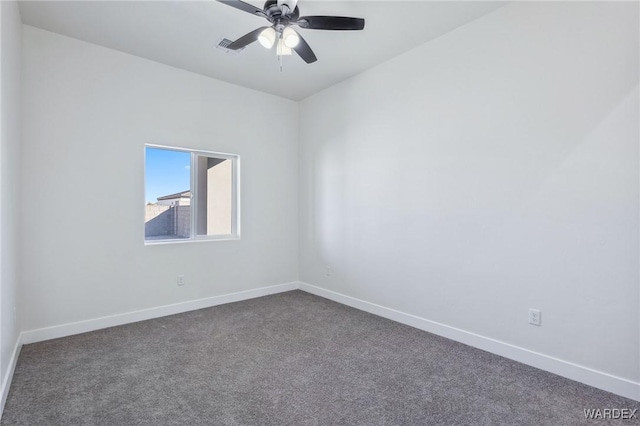 carpeted spare room featuring ceiling fan, visible vents, and baseboards