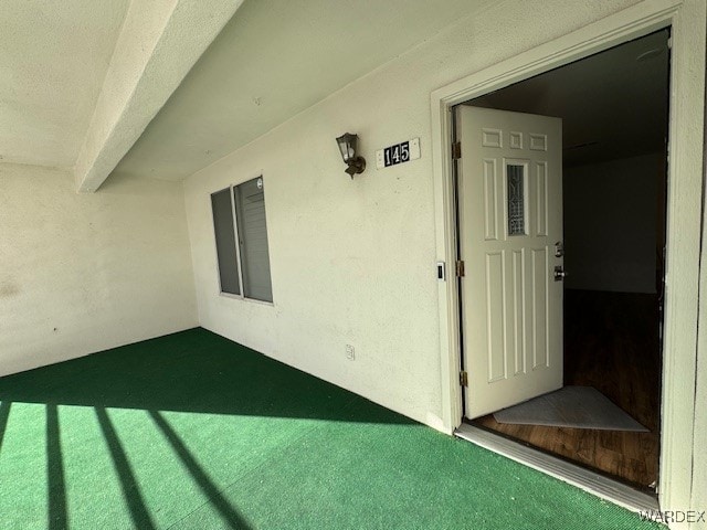 entrance to property with stucco siding