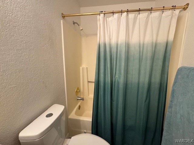 full bath with a textured wall, toilet, and shower / bathtub combination with curtain